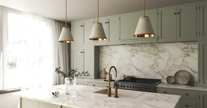 Elegant kitchen showing why homeowners choose marble slabs for countertops and backsplash, featuring white Carrara marble with gray veining and sage green cabinets