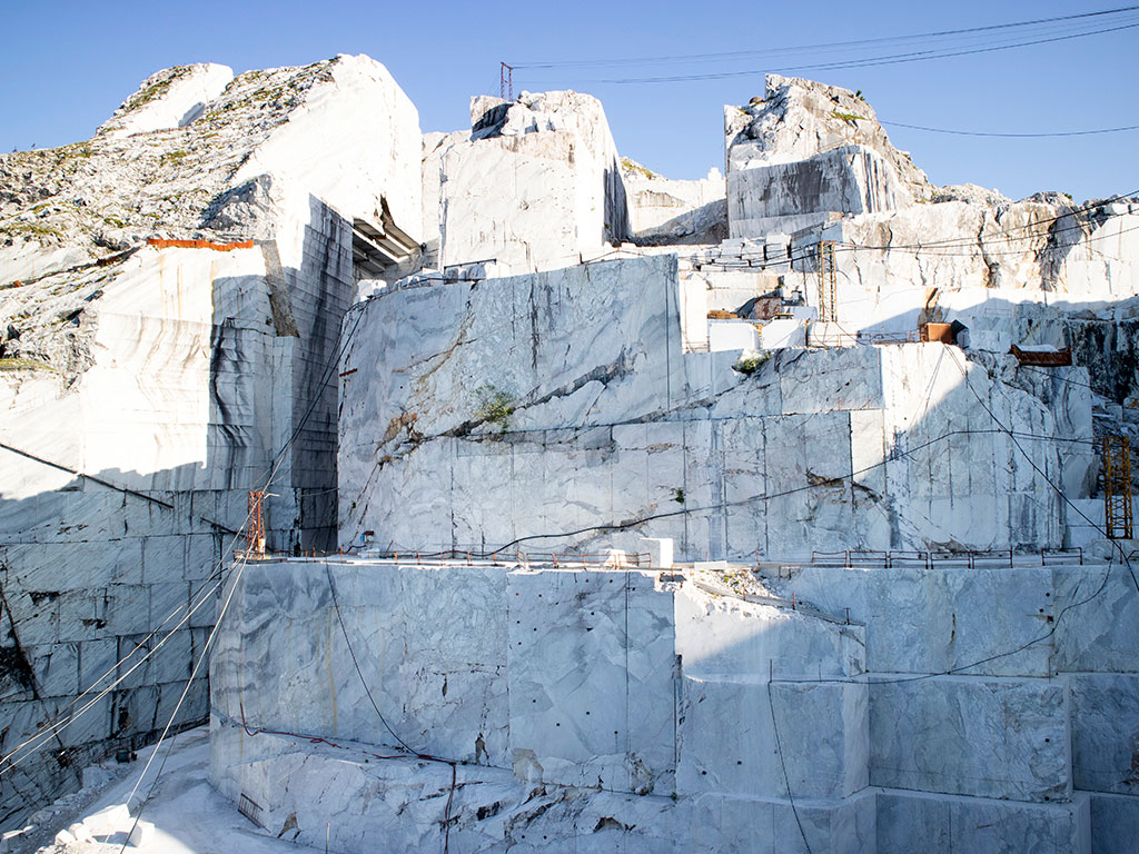 Marble quarry showcasing the natural beauty and extraction process of stones like Thassos marble and Carrara marble, highlighting their pristine white appearance and unique qualities.