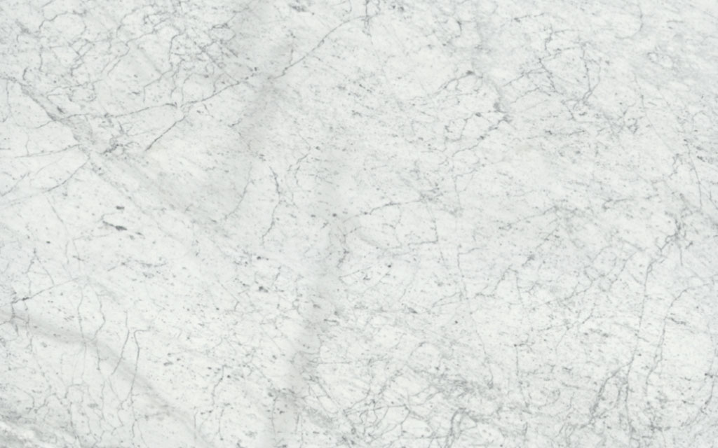 Carrara marble displaying this popular type of white marble with soft grey veins and white background, ideal for flooring, countertops, and versatile interior design applications