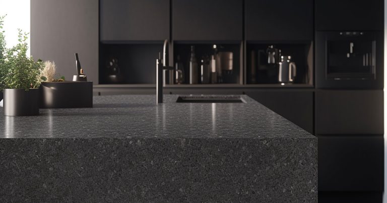Sleek dark quartz kitchen countertop with speckled finish on large island in contemporary black kitchen design, showcasing what kitchen countertop is best for modern minimalist style with integrated sink