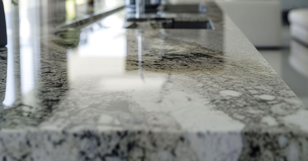 Close-up view of granite countertop surface showing natural stone patterns, mineral flecks, and polished finish that illustrate the aesthetic benefits in granite countertops pros and cons