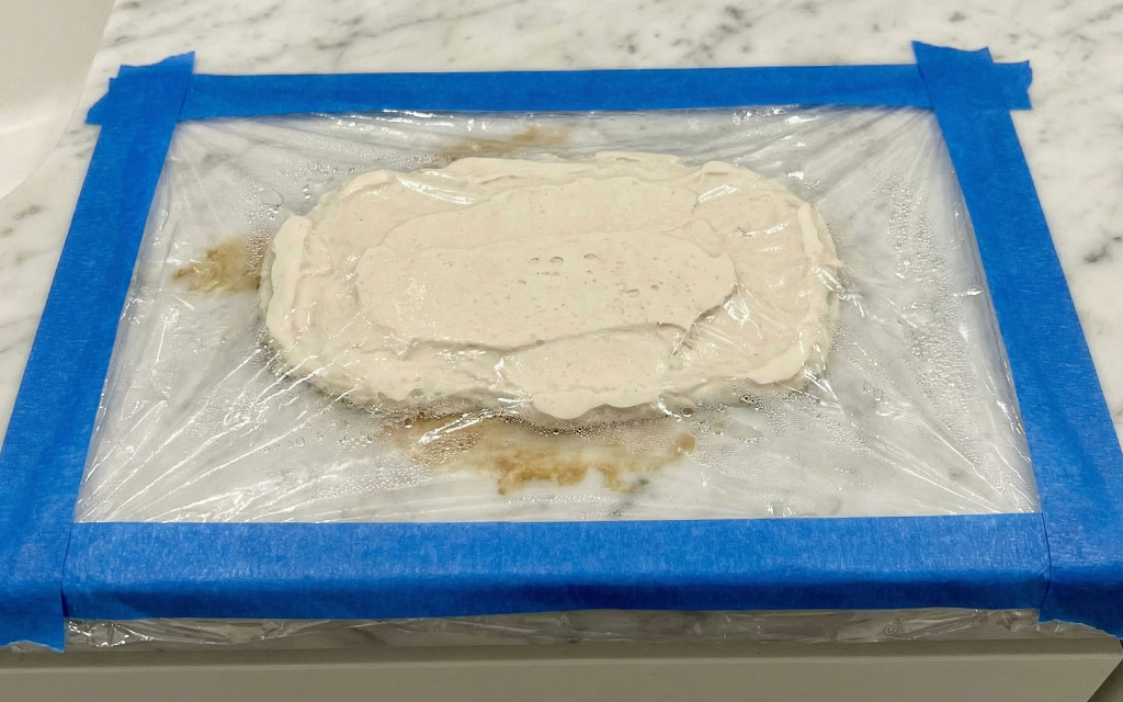 Baking soda poultice covered with plastic wrap and taped edges to remove marble stain